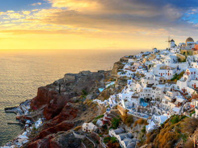 Picturesque sunset on famous view resort over Oia town on Santorini island, Greece, Europe. Summer holidays. Travel concept background.